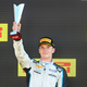 A photo of Dan Ticktum holding a trophy on the F2 podium.